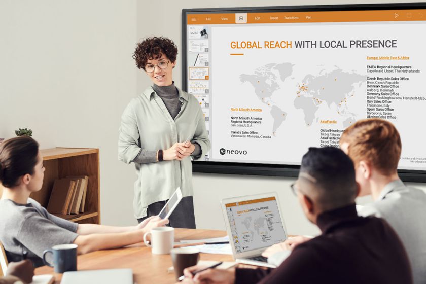 A group of people utilize screen mirroring on Meetboard IFP-Series interactive display in a huddle room