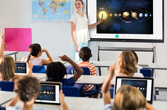 A teacher is teaching on Meetboard 3 interactive display with FMC-06 floor mounting cart in a classroom