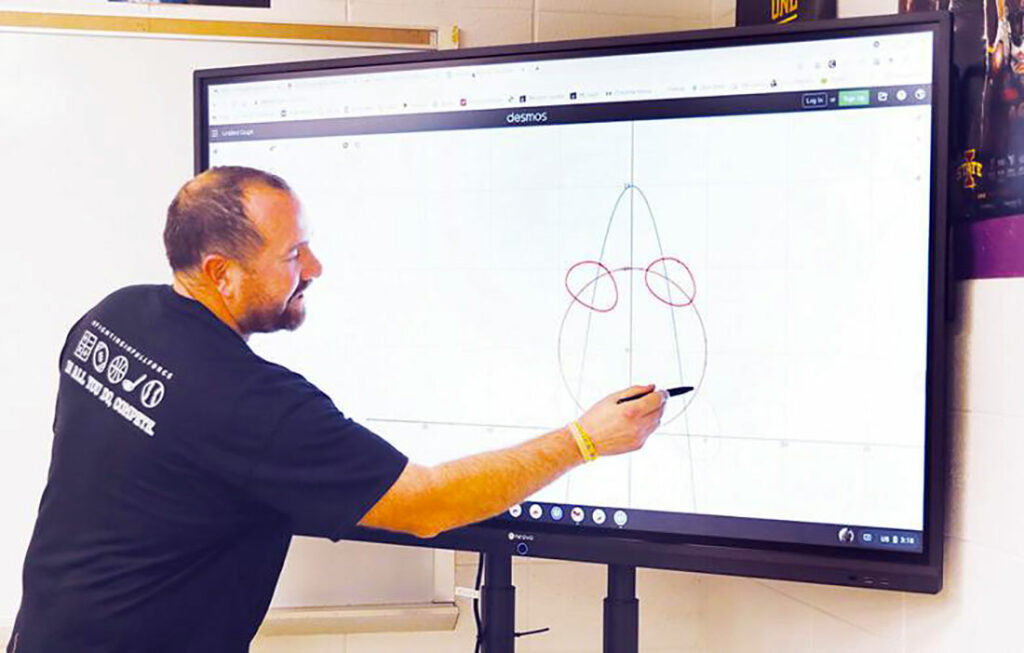 A middle school teacher is teaching Math on Meetboard interactive smart panel